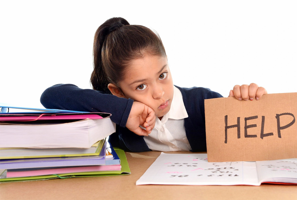 Student frowning holding a sign that says "help"